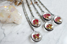 Load image into Gallery viewer, A pendant holds hand-picked tiny locally sourced rosebuds. They were pressed and dehydrated to preserve the natural shape and color, then carefully set in a glass in a stained glass technique. They'll last a lifetime for you to admire!