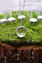 Load image into Gallery viewer, The pedant holds a cluster of real preserved dandelion seeds finished in a stained glass technique.