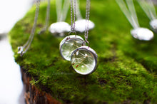 Load image into Gallery viewer, The pedant holds a cluster of real preserved dandelion seeds finished in a stained glass technique.