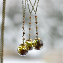Load image into Gallery viewer,  This necklace features preserved moss and a tiny alder pinecone forever suspended in the clear eco-resin. The sphere is complemented with a brass top and comes on 25 inches brass chain, adorned with small natural jaspers.   The sphere measures about 1 inch in diameter.