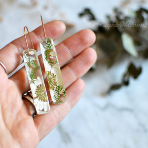 These gorgeous earrings feature handpicked pressed flowers preserved in the high-quality jewelry grade resin and sterling silver ear-wires.
