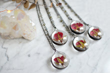 Load image into Gallery viewer, A pendant holds hand-picked tiny locally sourced rosebuds. They were pressed and dehydrated to preserve the natural shape and color, then carefully set in a glass in a stained glass technique. They&#39;ll last a lifetime for you to admire!