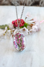 Load image into Gallery viewer, A pendant featuring pressed heather blossoms preserved in glass.