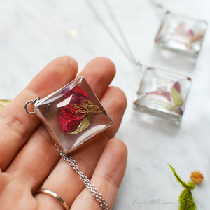 Pendant with tiny rosebud preserved in the class (stained glass technique). Measures approx. 1 x 1" and comes on the 20"  stainless steel cable chain (hypoallergenic and tarnish free).