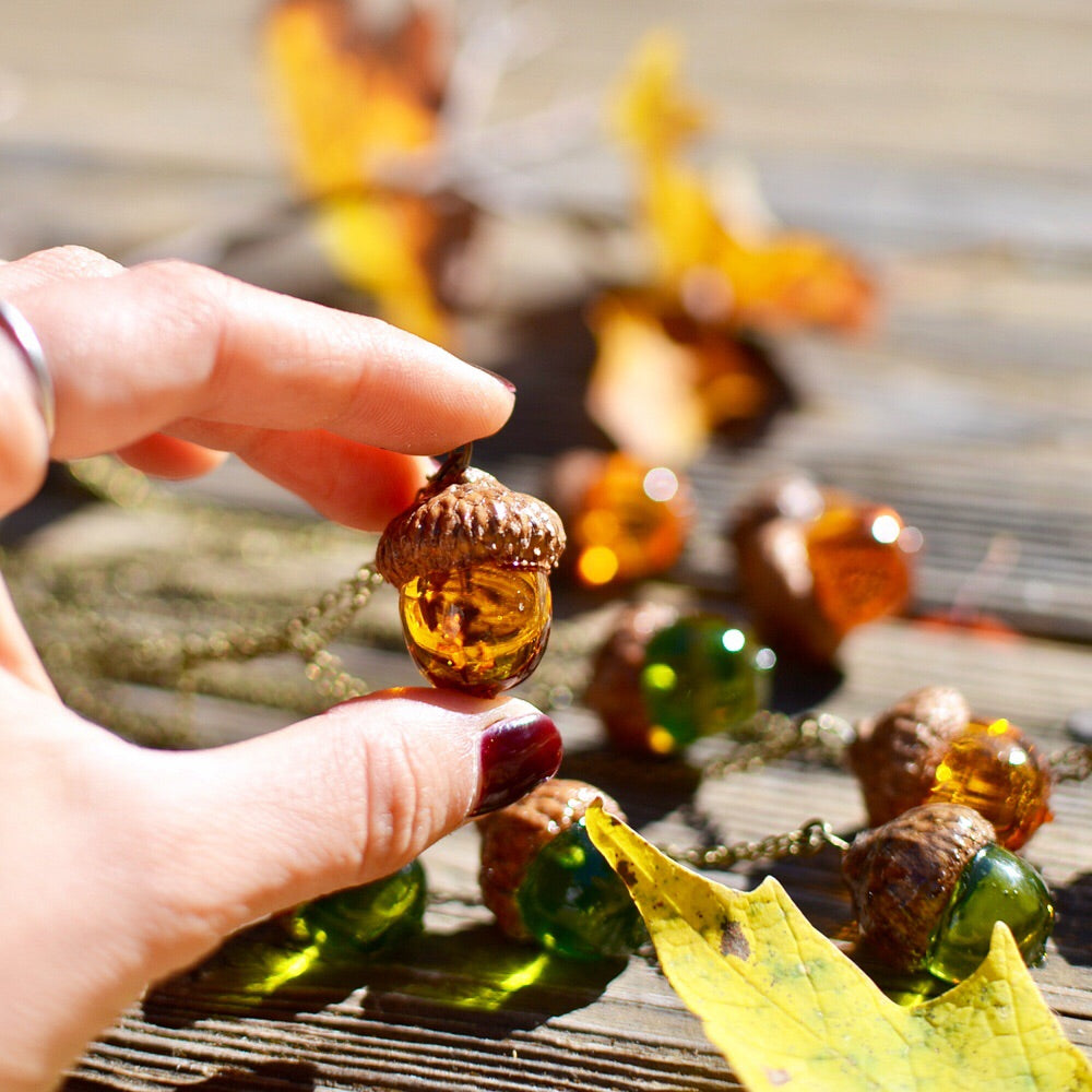  cute acorn pendant with the real wooden cap and amber resin body. 